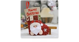 Detail of 3D Santa Claus plush on red Christmas stocking with burlap Merry Christmas cuff