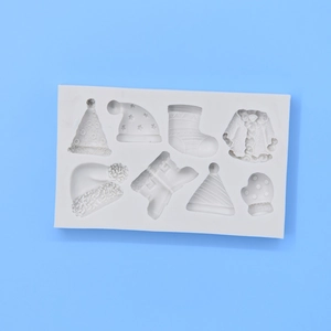 White silicone mold featuring 8 cavities with Christmas hats, boots, and winter glove shapes