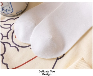 Close-up of the smooth knitted toe seam on a white cotton bear crew sock for women