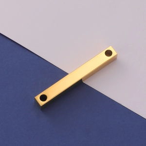 Macro view of gold stainless steel 3D bar pendant with dual holes and mirror finish