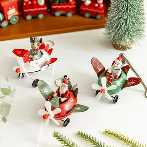Set of 3 vintage metal Christmas aircraft ornaments featuring Santa, reindeer and snowman