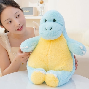 Soft light blue and yellow dinosaur plush pillow held in a cozy home setting