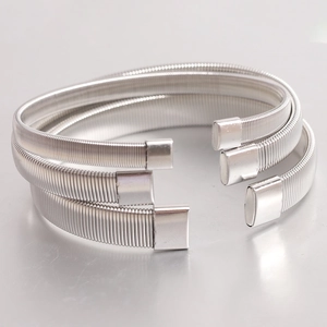 Detailed view of silver elastic metal sleeve garters with coiled wire texture in three-piece set