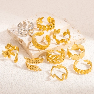 Minimalist gold and silver open rings with hollow leaf and feather designs on stone
