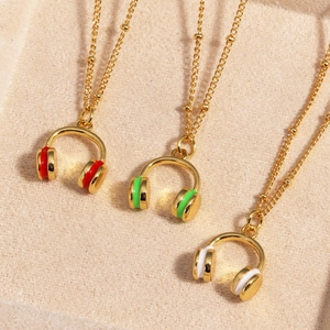 Detailed macro view of colorful enamel headphone pendants on gold beaded chain necklaces
