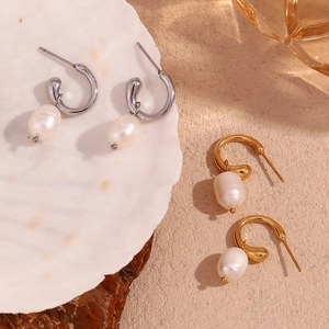 Elegant gold and silver hoop earrings with freshwater pearl drops on natural shells