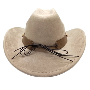 Close-up of khaki suede cowboy hat featuring a leather band with metal rivets and a bow knot