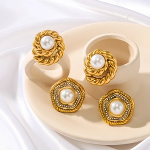 Vintage gold stainless steel earrings with pearls and zircon set on white silk tray