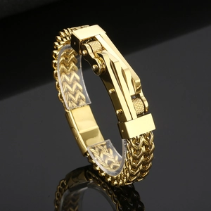 Sleek gold-plated stainless steel motorcycle chain bracelet for men in a dark background