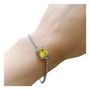Elegant silver tennis bracelet featuring a rectangular yellow zircon center and halo design