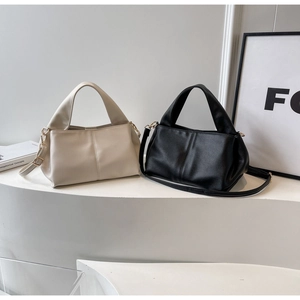Minimalist beige and black PU leather handbags showcased on a modern aesthetic shelf