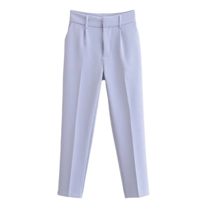 Detail view of high-waisted pale lavender trousers with smooth fabric texture