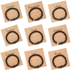 Macro view of nine zodiac bead bracelets with natural stones on kraft paper display cards