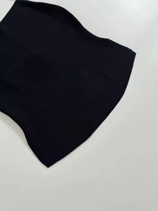 Detailed view of black knitted fabric with fine texture on a white background