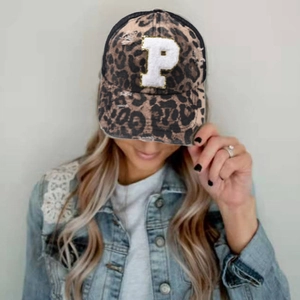 Detail of leopard print baseball cap with P embroidery and distressed brim texture