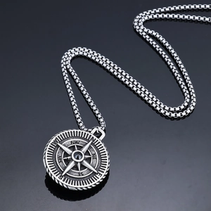 Detailed macro view of vintage silver Viking compass pendant with ornate metal engraving