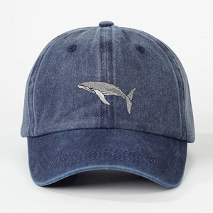 Vintage navy blue washed denim baseball cap featuring detailed whale embroidery on the front
