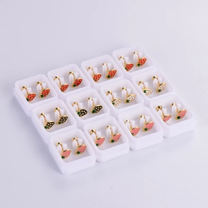 Detailed grid of twelve pairs of colorful strawberry enamel stud earrings in boxes