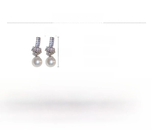 Detailed view of luxury bow knot earrings with zircon crystals and faux pearls