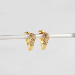 Macro view of 18K gold plated heart earrings with pavé set zirconia crystals on a stand