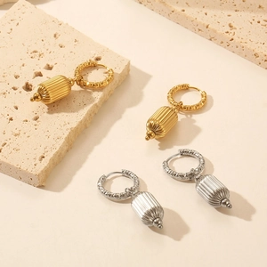 Detail showing French vintage C-shaped hoop earrings in gold and silver metal finishes