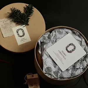 Minimalist kraft paper round gift box set with Christmas greeting card and pine decoration