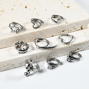 Punk style silver stainless steel earrings featuring star, heart, skull and snake designs