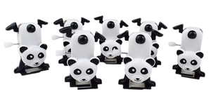 Detail of seven wind-up panda toys made of plastic with white mechanical spring knobs