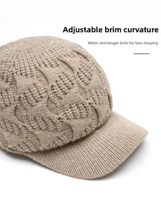 Detail of light beige knitted baseball cap featuring a foldable brim and thick cable texture