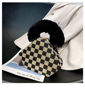 Detailed view of a hexagonal checkered handbag with a black fluffy faux fur top handle