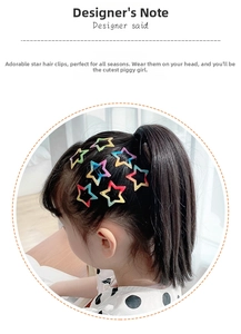 Détail de barrettes en forme d'étoile avec dégradé de couleurs sur une fillette