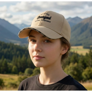 Detail of khaki outdoor baseball cap with black letter embroidery and branded sport brim