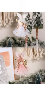 Detailed view of pink and white angel doll ornaments with glitter stars and mesh skirts