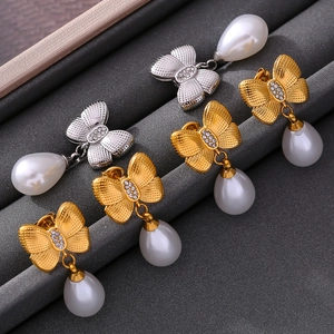 Elegant bow-shaped drop earrings with water drop pearls in gold and silver finish