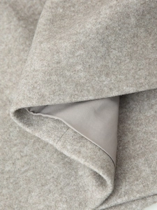 Close-up of premium wool blend fabric texture with smooth inner lining for winter coat