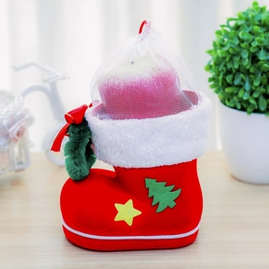 Detail of red flocked Christmas boot with white fur trim and mesh gift bag insert