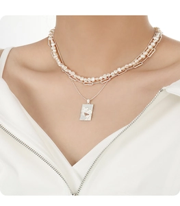 Detail of double-layer necklace with freshwater pearls and silver square pendant