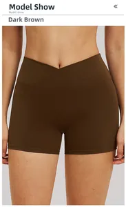 Detail of high-waisted yoga shorts in dark coffee brown with cross-waist design