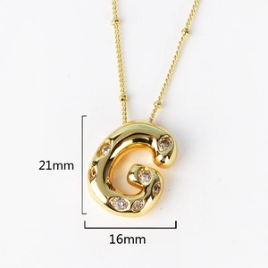 Close-up of gold iced-out letter G pendant with diamonds, size 21mm by 16mm