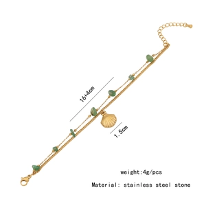 Detailed view of a double-layer stainless steel bracelet with shell pendant and green stones
