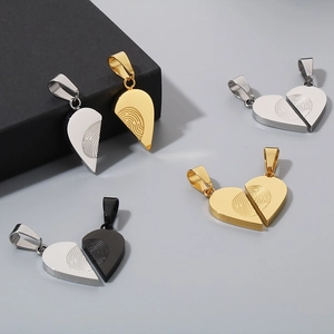 Detailed macro view of heart-shaped fingerprint pendants in multiple metallic finishes