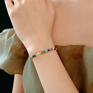 Close-up of a colorful beaded stone bracelet worn on wrist with 4mm mixed beads