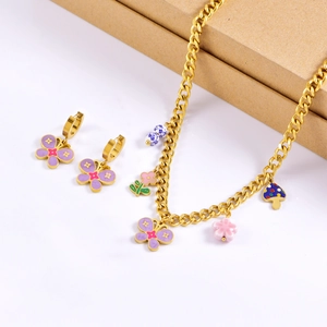 Detail of gold chain necklace set with purple butterfly, floral, and porcelain charms