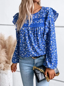Detail of floral long sleeve shirt with ruffle trim and delicate lace on the chest