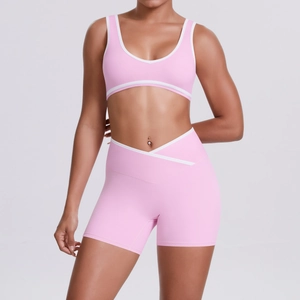 Detail of high-waisted crossover V-waistband and contrast trim on pink yoga set