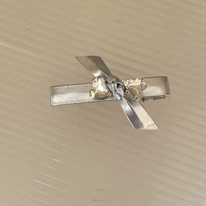 Dettaglio del fermaglio per capelli argento con fiocco e strass a forma di cuore lucido