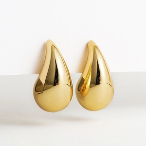 Close-up of teardrop-shaped 18K gold plated earrings with high-shine polished finish