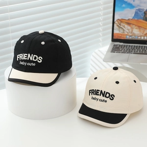 Detail view of two-tone baby baseball caps featuring FRIENDS baby cute embroidery