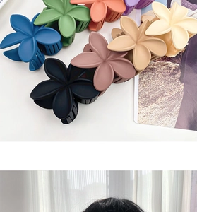 Detailed view of matte flower hair claws in various colors with secure grip design