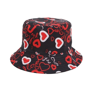 Black bucket hat with red heart patterns and white graffiti print for sun protection